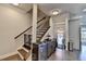 Hallway with hardwood floors, wooden stairs, wine fridge, and view of front entrance at 4007 Dunwoody Trce, Atlanta, GA 30338
