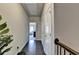 Hallway with access to a living space, storage closets, and hardwood floors at 4007 Dunwoody Trce, Atlanta, GA 30338