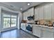 Elegant kitchen with stainless steel appliances, granite countertops, and mosaic backsplash at 4007 Dunwoody Trce, Atlanta, GA 30338