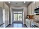 Well-lit kitchen featuring white cabinets, stainless appliances, and a large window at 4007 Dunwoody Trce, Atlanta, GA 30338