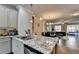 Kitchen island with granite countertops overlooking the open living space with hardwood floors at 4007 Dunwoody Trce, Atlanta, GA 30338