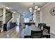 Open-concept living room flows into dining area and kitchen, featuring hardwood floors and natural light at 4007 Dunwoody Trce, Atlanta, GA 30338