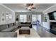 Cozy living room with hardwood floors, a ceiling fan, comfortable seating, and a fireplace at 4007 Dunwoody Trce, Atlanta, GA 30338