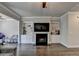 Living room featuring built-in bookshelves, fireplace, hardwood floors, and ample natural light at 4007 Dunwoody Trce, Atlanta, GA 30338
