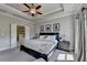 Spacious main bedroom featuring a trey ceiling, neutral colors, and an ensuite bathroom at 4007 Dunwoody Trce, Atlanta, GA 30338