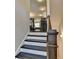 Staircase with white risers and dark treads with a decorative post at the bottom at 4007 Dunwoody Trce, Atlanta, GA 30338