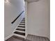 Staircase with a dark wood handrail and bench seating at the bottom of the stairs at 4007 Dunwoody Trce, Atlanta, GA 30338