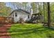 Spacious backyard featuring a custom deck with stairs down to a lush green lawn at 5845 Shannon Dr, Cumming, GA 30040