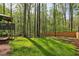 Expansive backyard featuring lush green grass, mature trees, and a charming deck, perfect for outdoor enjoyment at 5845 Shannon Dr, Cumming, GA 30040