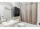 This bathroom features a shower and tub combination, as well as built in storage at 5845 Shannon Dr, Cumming, GA 30040