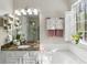 This bright bathroom has a large window with garden views, marble counters, and a glass-enclosed shower at 5845 Shannon Dr, Cumming, GA 30040