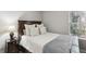 This neutral bedroom is illuminated by natural light from the window, making it bright and airy at 5845 Shannon Dr, Cumming, GA 30040