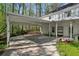 Back of home with a carport, showing an ample driveway, and mature trees creating a private setting at 5845 Shannon Dr, Cumming, GA 30040