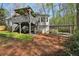 Back of home featuring a deck, a carport, and a spacious yard offering privacy and room for outdoor activities at 5845 Shannon Dr, Cumming, GA 30040