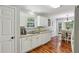 Bright and functional kitchen with white cabinets, granite countertops, hardwood floors and stainless-steel dishwasher at 5845 Shannon Dr, Cumming, GA 30040