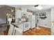 Well-designed kitchen with white cabinetry, granite countertops, and hardwood floors in an open-concept space at 5845 Shannon Dr, Cumming, GA 30040