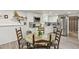 Bright kitchen featuring white cabinets, stainless steel appliances, a granite countertop table, and modern fixtures at 5845 Shannon Dr, Cumming, GA 30040