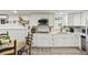 Well-equipped kitchen with white cabinetry, sleek stainless steel appliances, and a cozy eat-in area at 5845 Shannon Dr, Cumming, GA 30040