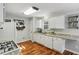 Functional kitchen with white cabinets, granite countertops, hardwood floors and modern appliances at 5845 Shannon Dr, Cumming, GA 30040