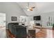 Comfortable living room with fireplace, hardwood floors, a ceiling fan and plenty of space for Gathering and friends at 5845 Shannon Dr, Cumming, GA 30040