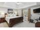This bright main bedroom boasts a trey ceiling, neutral paint, and large windows for natural light at 5845 Shannon Dr, Cumming, GA 30040