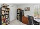 This home office features natural light from the large window and a built-in bookshelf for extra storage at 5845 Shannon Dr, Cumming, GA 30040