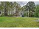 Expansive backyard with mature trees, a white gazebo, and a detached garage at 2198 Kings Forest Se Dr, Conyers, GA 30013