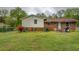 View of backyard featuring patio, grill, and partially fenced yard with mature trees at 2198 Kings Forest Se Dr, Conyers, GA 30013
