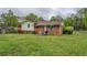 View of backyard featuring patio, grill, and partially fenced yard with mature trees at 2198 Kings Forest Se Dr, Conyers, GA 30013