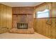 Close up of brick fireplace in finished basement with paneled walls and carpet flooring at 2198 Kings Forest Se Dr, Conyers, GA 30013