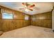 Spacious finished basement with paneled walls, carpet flooring, and natural light from windows at 2198 Kings Forest Se Dr, Conyers, GA 30013