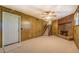 View of finished basement with paneled walls, brick fireplace, and staircase to upper level at 2198 Kings Forest Se Dr, Conyers, GA 30013