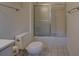 Compact bathroom featuring a toilet, tiled floors, and a shower with glass doors at 2198 Kings Forest Se Dr, Conyers, GA 30013