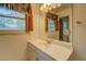 Bright bathroom with a large mirror, ample counter space and wooden window shutters at 2198 Kings Forest Se Dr, Conyers, GA 30013