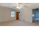 Bedroom features carpet, ceiling fan with light, and view into another room at 2198 Kings Forest Se Dr, Conyers, GA 30013