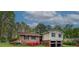 Charming brick and vinyl home featuring a two-car garage and colorful blooming azaleas at 2198 Kings Forest Se Dr, Conyers, GA 30013
