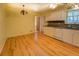 Well-lit kitchen with white cabinets, modern appliances, and hardwood floors at 2198 Kings Forest Se Dr, Conyers, GA 30013