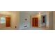 A multi-part view of a bright living area with carpet, wooden doors, and a staircase at 2198 Kings Forest Se Dr, Conyers, GA 30013