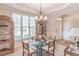 Cozy dining room featuring natural light, a modern chandelier, and seating for four at 3853 Coralberry Ct, Dacula, GA 30019