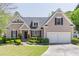 Charming two-story home boasts a well-manicured lawn, lush landscaping, and a two-car garage at 3853 Coralberry Ct, Dacula, GA 30019