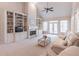 Elegant living room featuring built-in bookcases, a fireplace, and comfortable seating at 3853 Coralberry Ct, Dacula, GA 30019