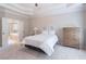 Bright main bedroom with an ensuite bathroom and a chest of drawers at 3853 Coralberry Ct, Dacula, GA 30019