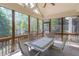 Inviting screened porch features tiled flooring, ceiling fan, and a dining table with seating for four at 3853 Coralberry Ct, Dacula, GA 30019