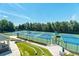 Aerial view of multiple well-maintained tennis courts surrounded by lush greenery at 3853 Coralberry Ct, Dacula, GA 30019