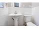 This bright bathroom features a classic pedestal sink and clean, white tile at 3905 Kirksford Dr, Decatur, GA 30035