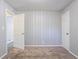 A bedroom with carpeting and paneled walls shows an open door to a hallway at 3905 Kirksford Dr, Decatur, GA 30035