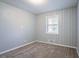 Neutral bedroom with carpeting, one window, and paneled walls at 3905 Kirksford Dr, Decatur, GA 30035