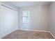 Small bedroom with carpeting, closet, and a window at 3905 Kirksford Dr, Decatur, GA 30035