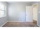 Bedroom showing an open door to a hallway, a door to a closet, and a window at 3905 Kirksford Dr, Decatur, GA 30035