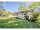 View of brick exterior of home with a well-maintained lawn and landscaping at 3905 Kirksford Dr, Decatur, GA 30035
